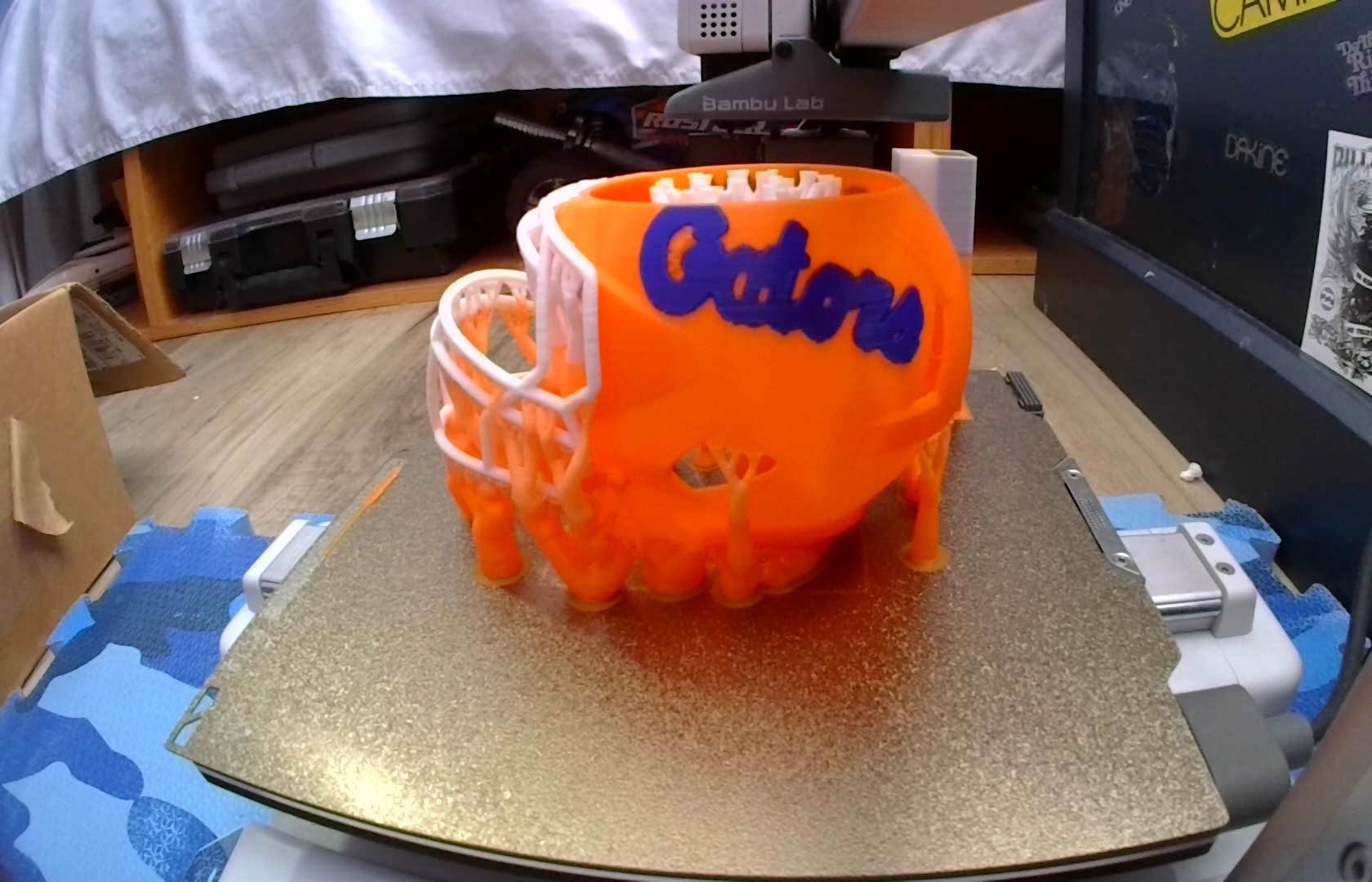 Orange and blue Gators-themed model being 3D printed